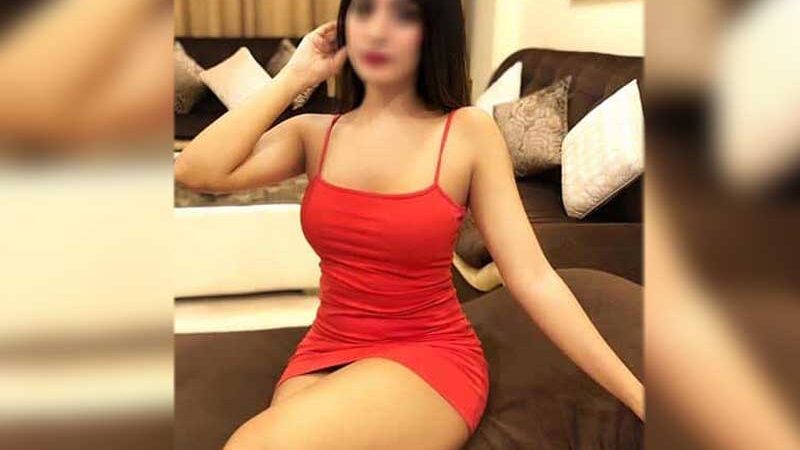 sexy girl in short red dress in a hotel room